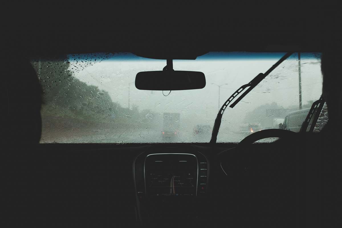 car two person driving on rainy road highway