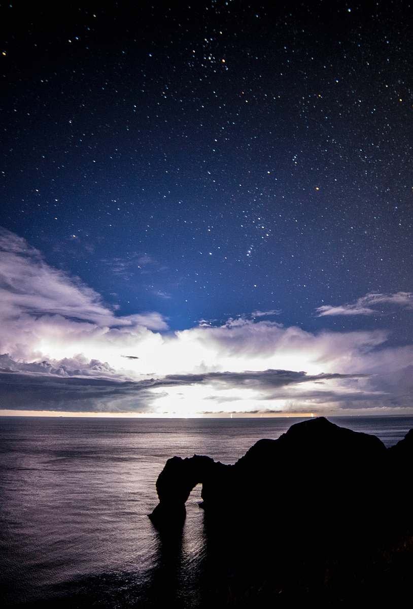 blue body of water across mountain night