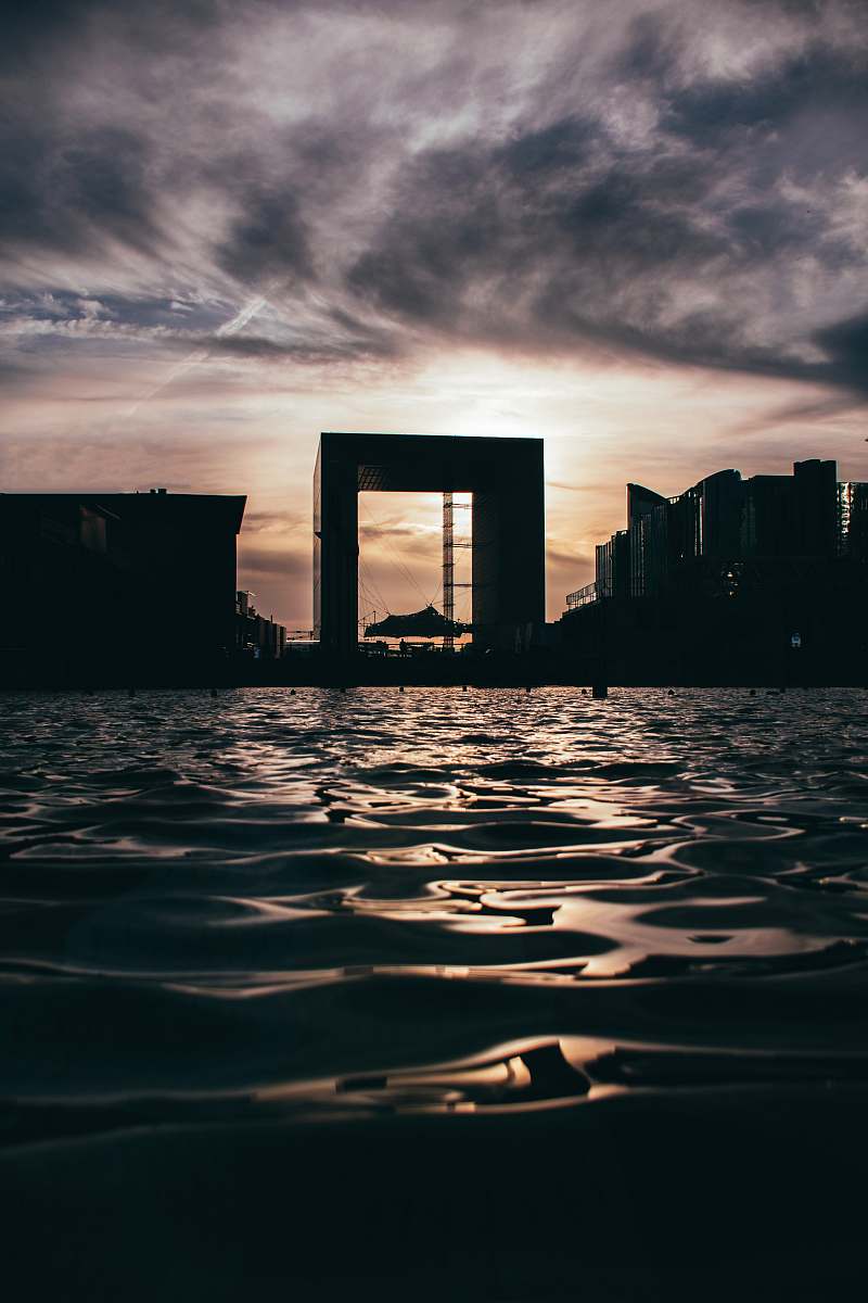 outdoors body of water near high buildings at golden hour sunset