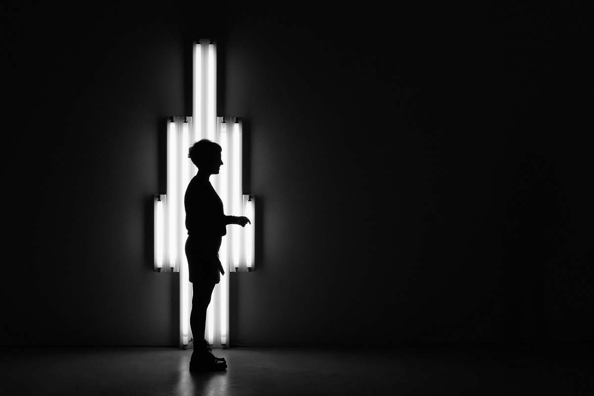 people boy standing in front of lamp black-and-white