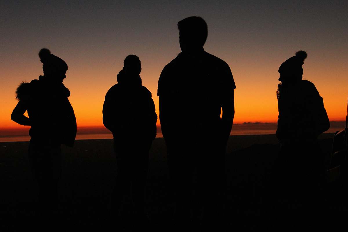 person four persons standing during sunset people