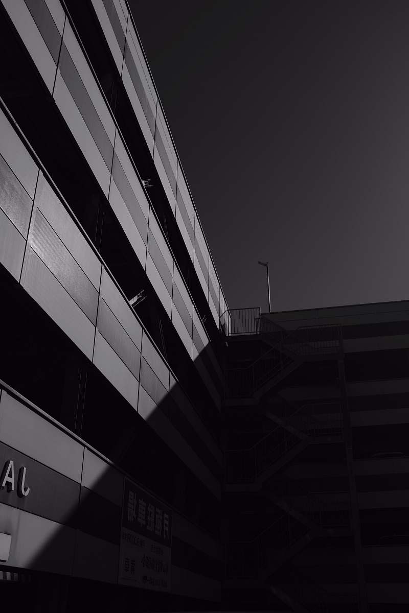 black-and-white grayscale photography of buildings with sun shadow matsuyama