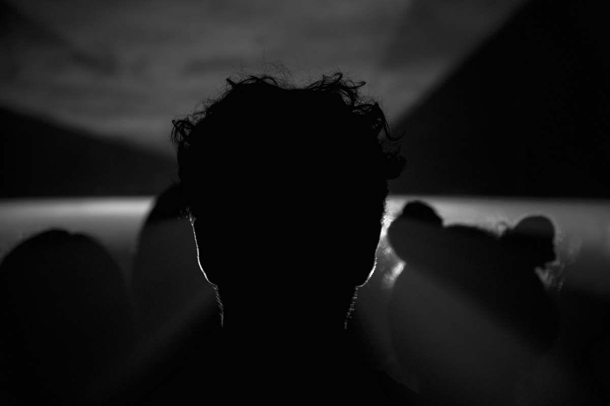 black-and-white grayscale photography of silhouette of man flare