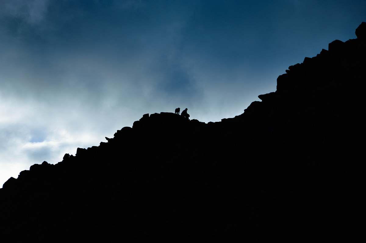 mountain low angle of person on rock cliff hike
