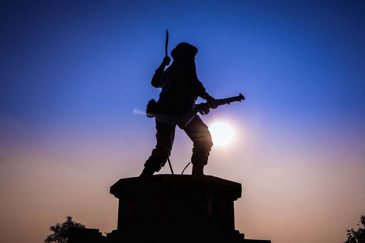 human man holding rifle statue person