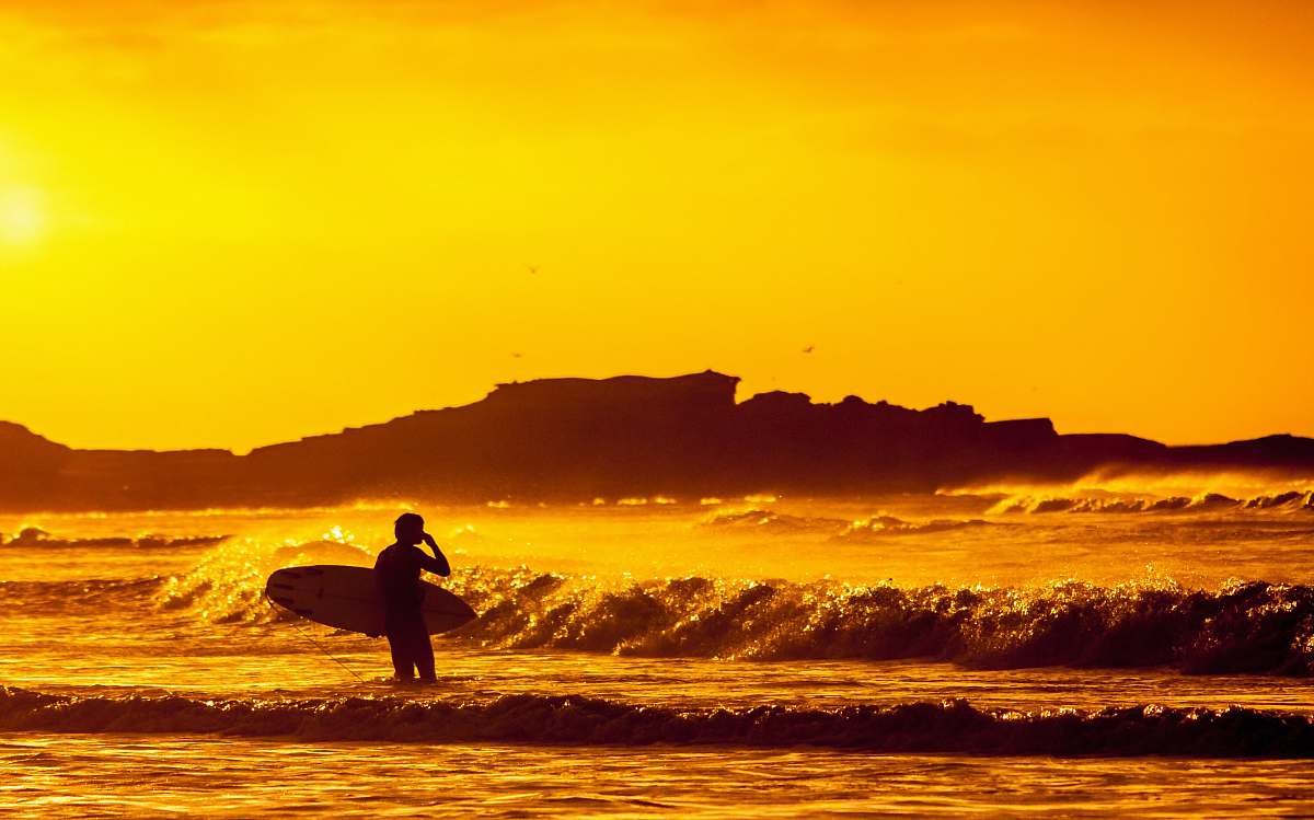 ocean man holding white surfboard surfer