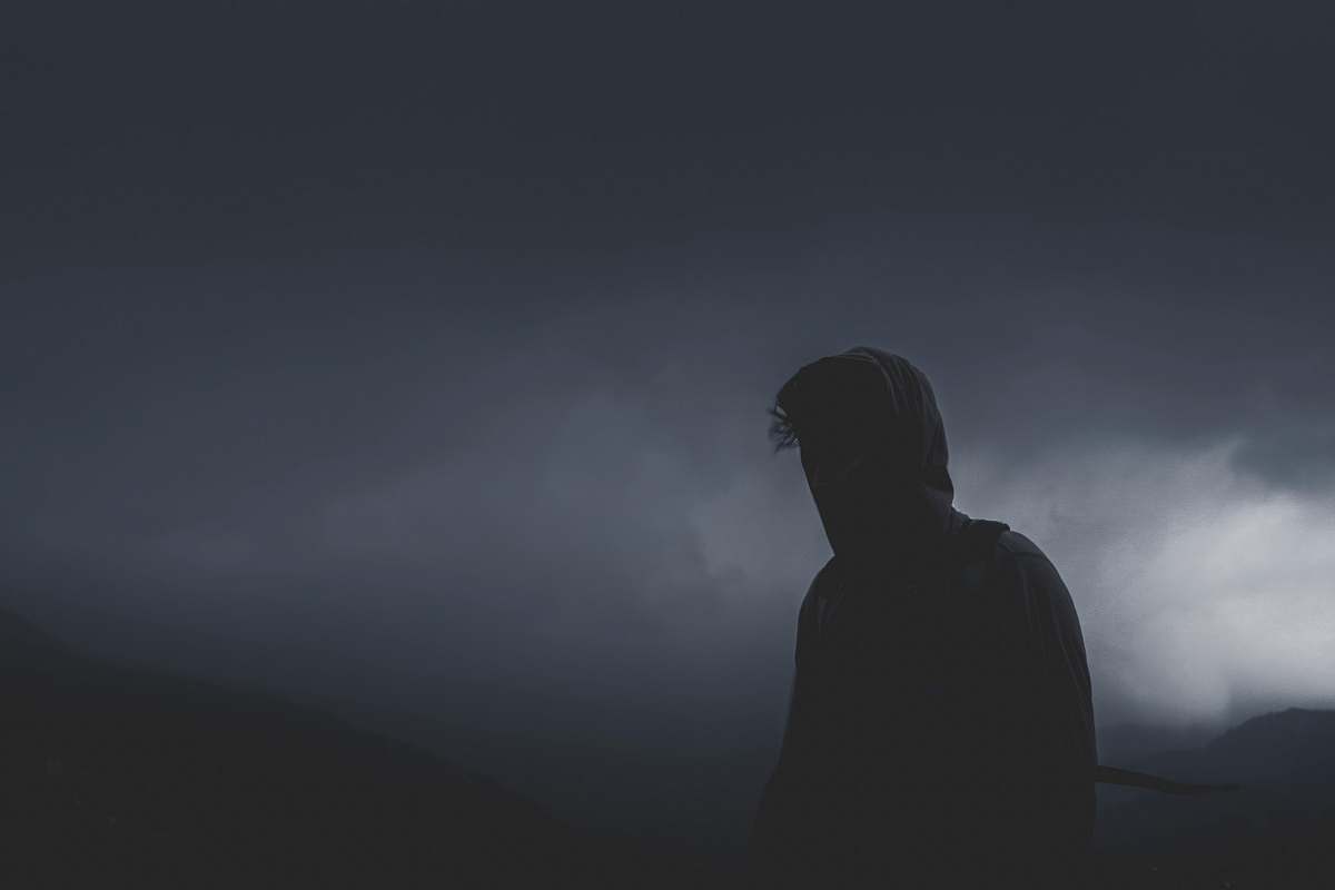 person man looking forward on cloudy path grey