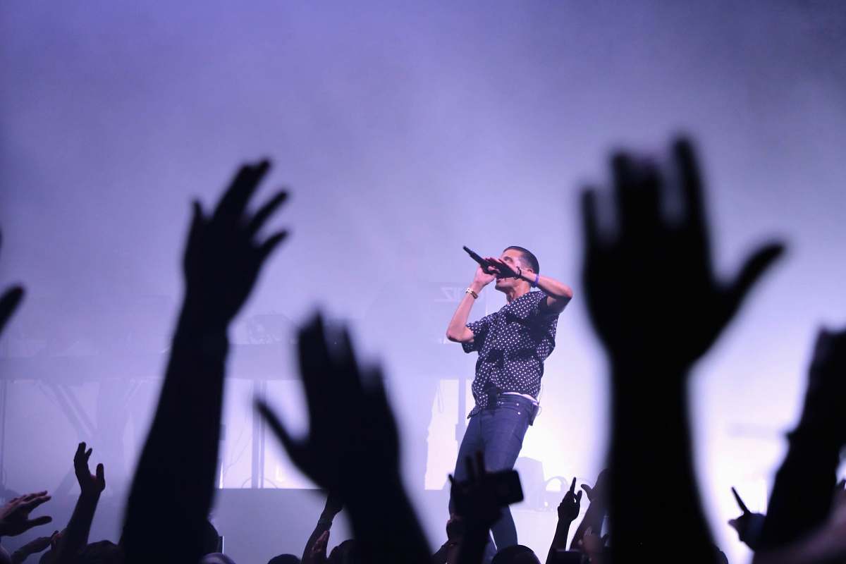 human man singing on stage person