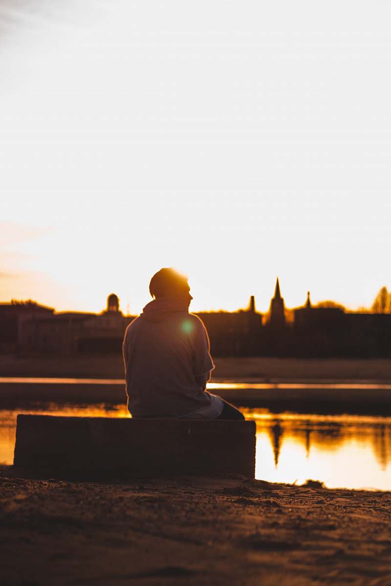 human man sitting on rectangular box person
