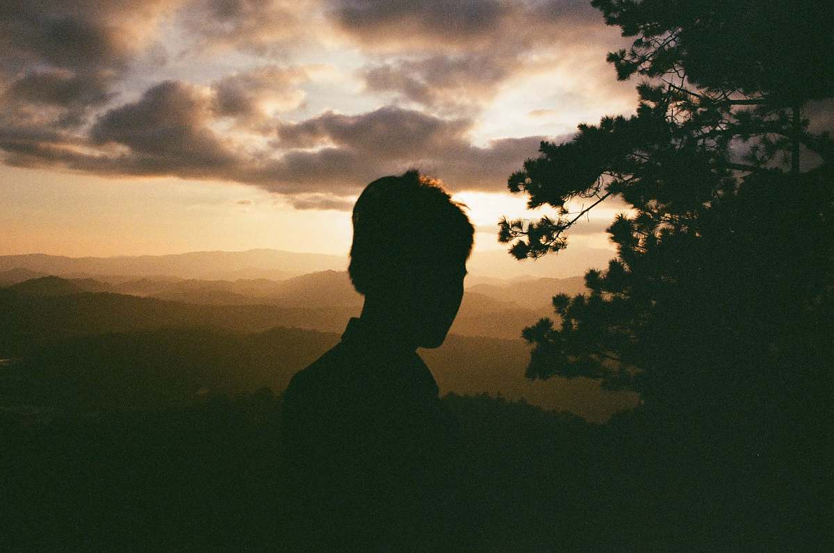 flare man standing beside tree light