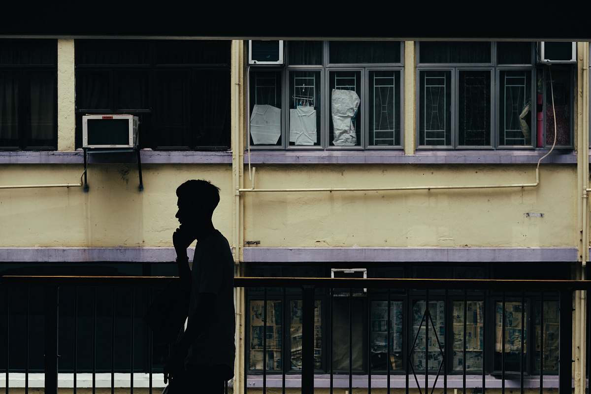 person man standing by rail in building people