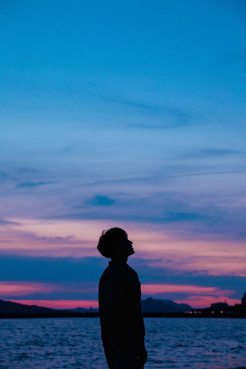 person man standing near beach water