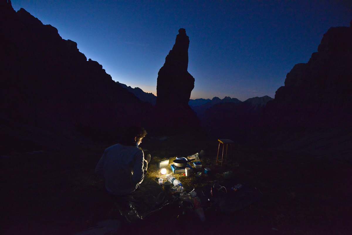 human man using light during nighttime camping