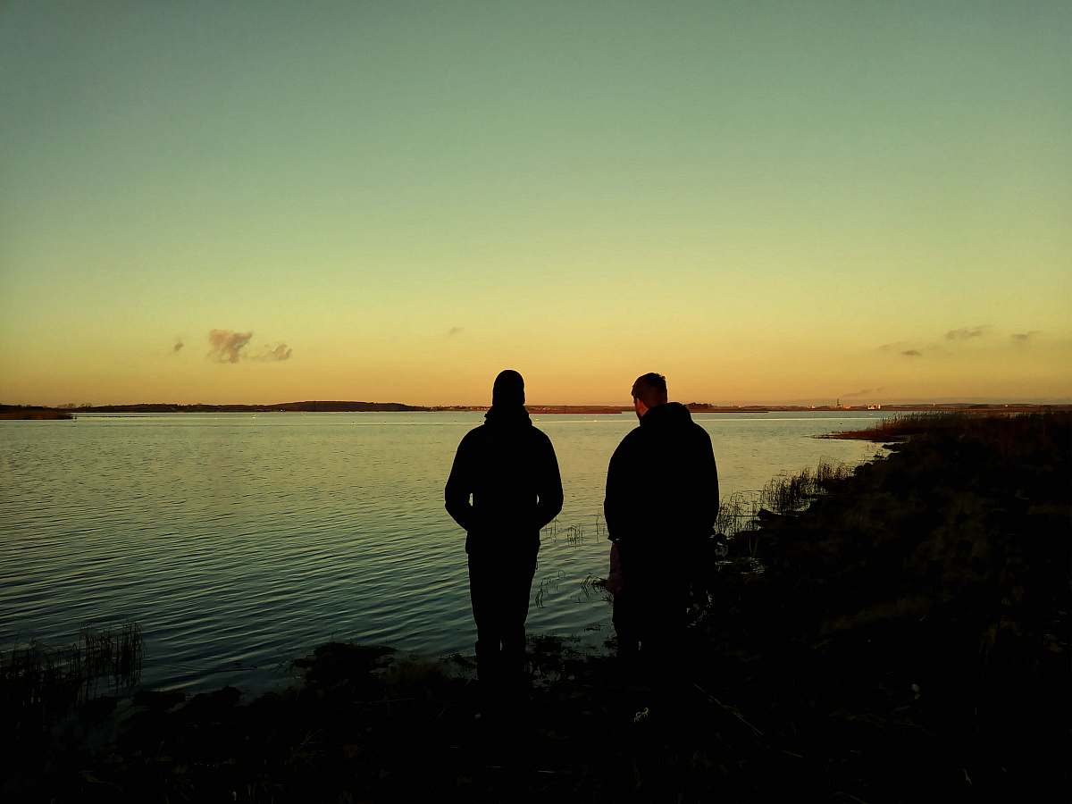 human men standing beside river person