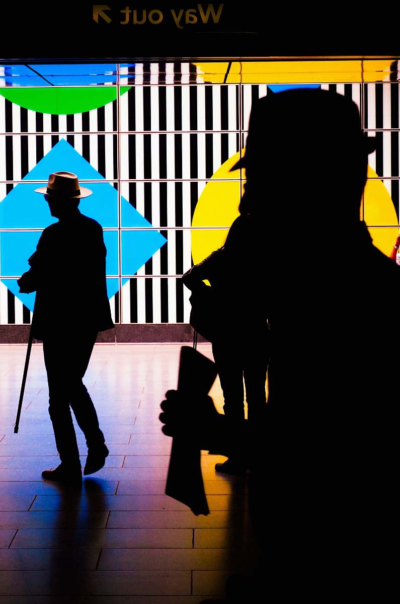 human people by a colorful screen TV person
