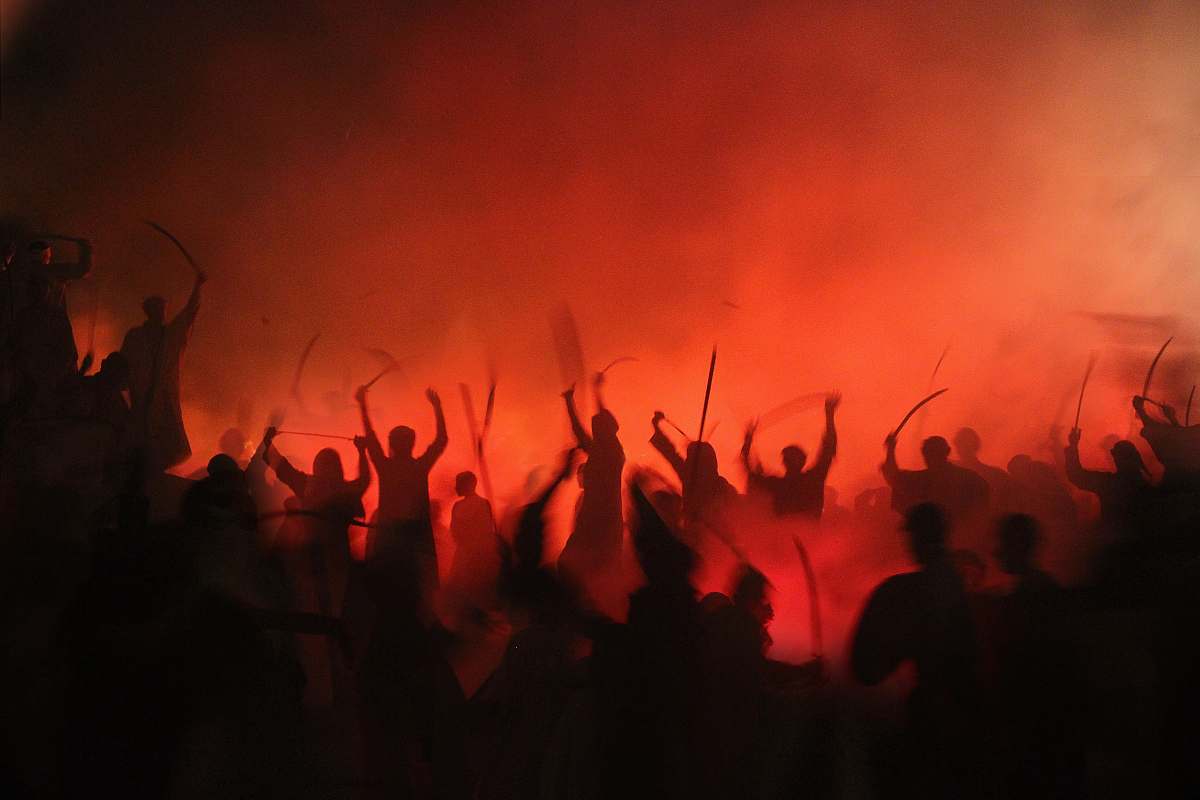 red people gathering on street during nighttime human