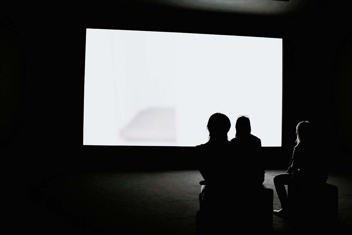 black-and-white people looking on projection screen white