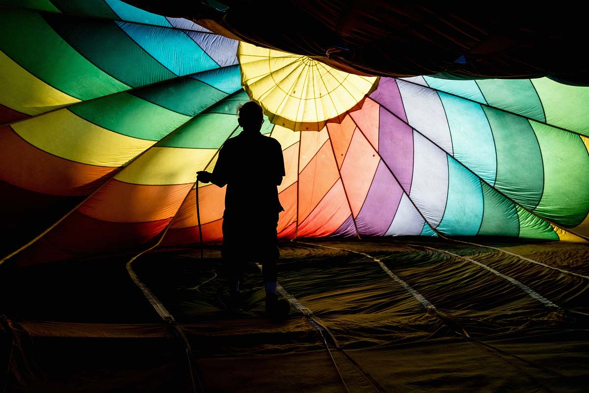 person person holding parachute hot air balloon