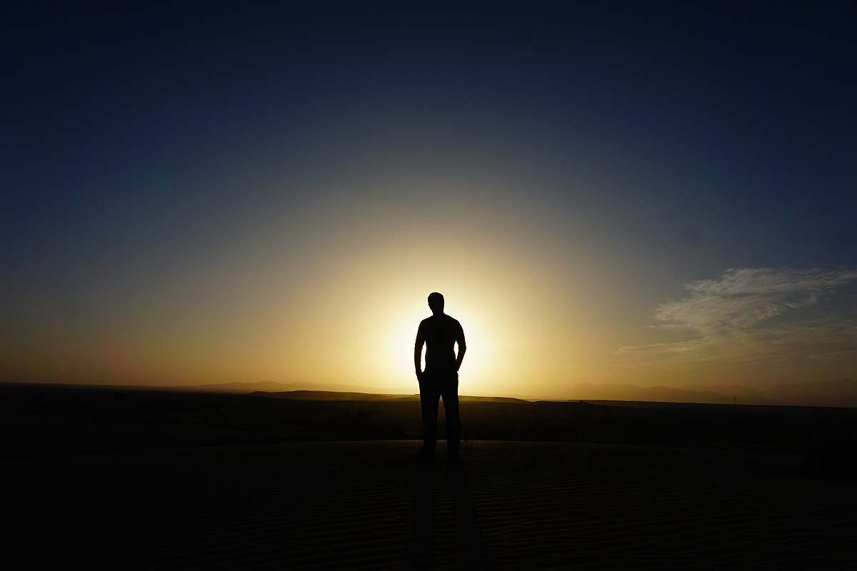 human person standing at the field during golden hour person