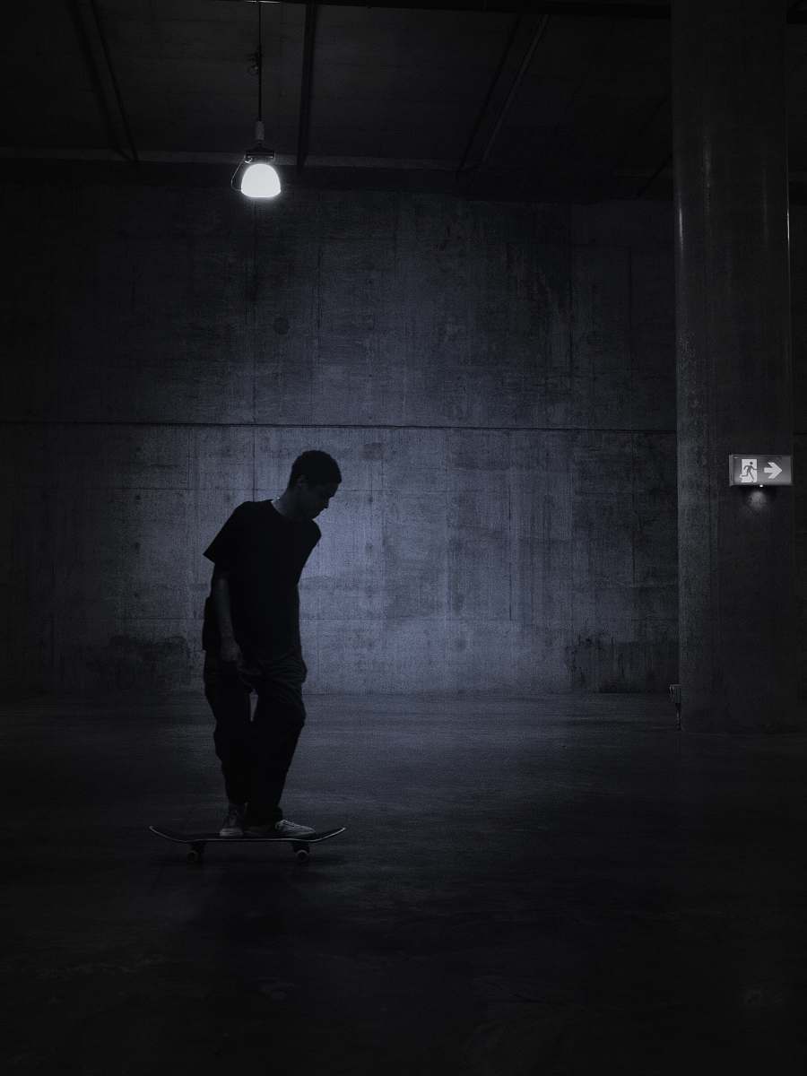 lighting person standing in room grey