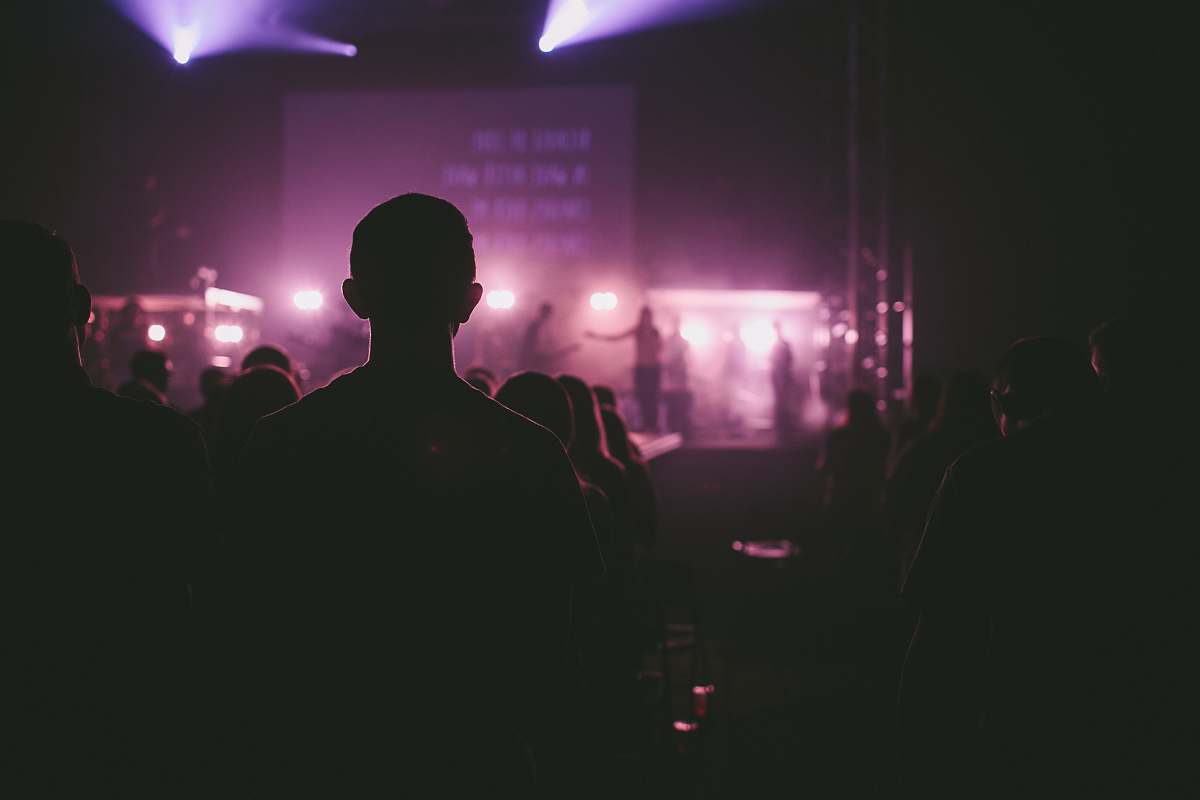 music photo of man facing on stage stage