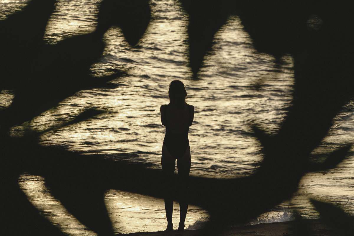 human photo of person standing near body of water person