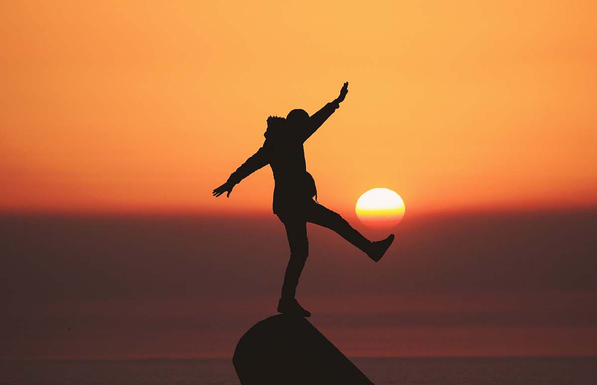 asilah photo of silhouette photo of man standing on rock morocco