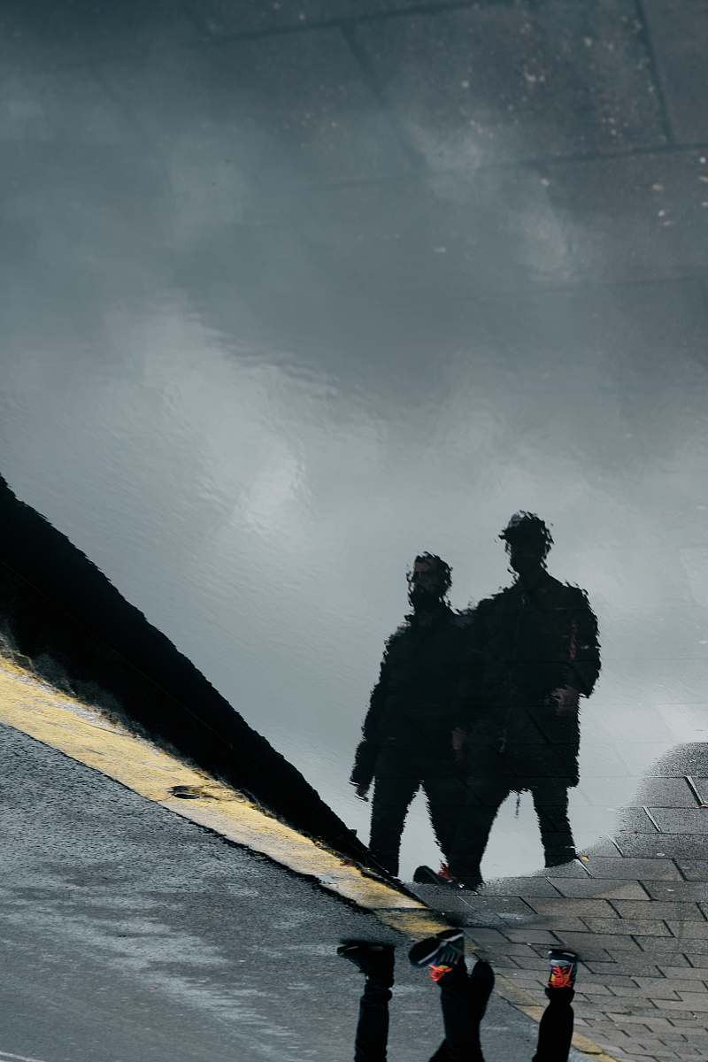 human reflection silhouette of two men on water person