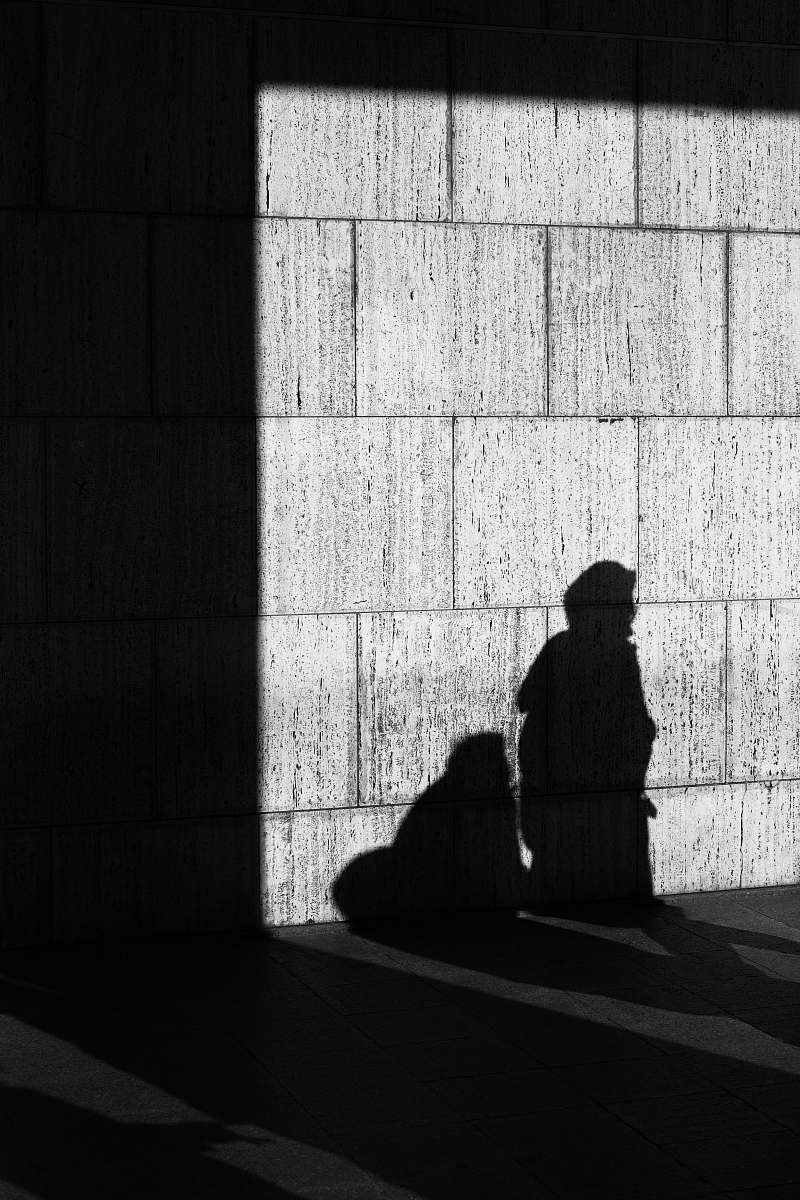 black-and-white shadow of person on wall wall