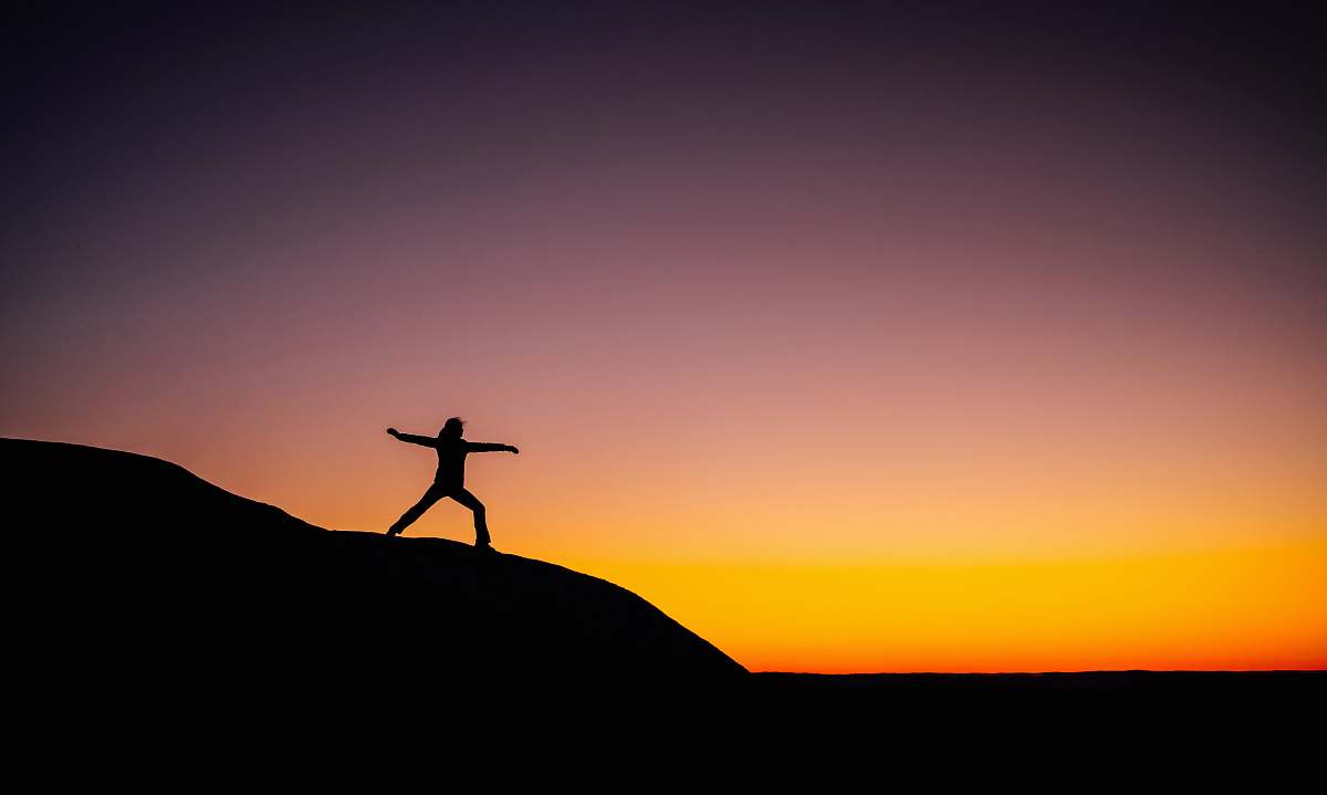 outdoors shillouette photo of person standing at the peak nature