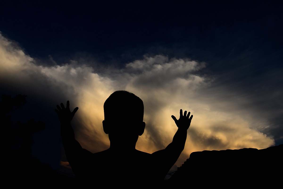 cloud silhouette man looking at the sky person