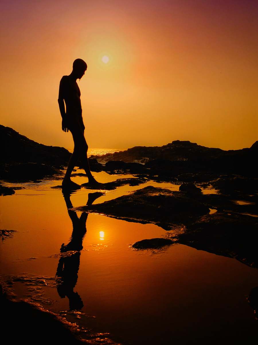 flare silhouette of a man at sunset light