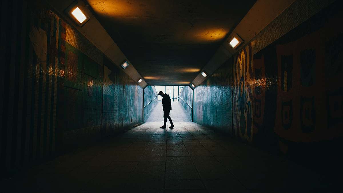 tunnel silhouette of a man inside subway underpass