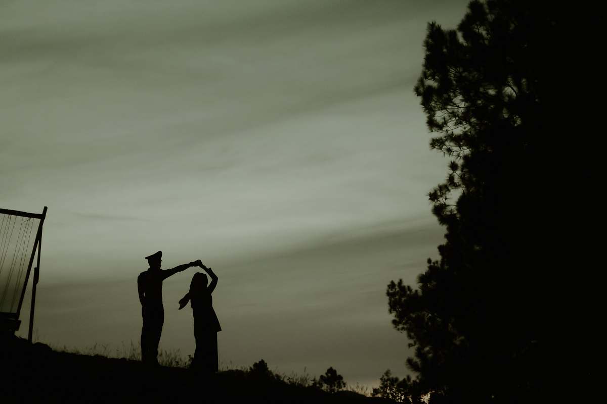 human silhouette of dancing couple near tree during night person