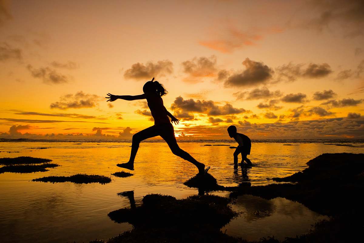 human silhouette of girl and boy at the beach person