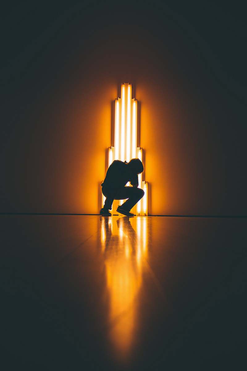 neon silhouette of man crouching sfmoma museum store