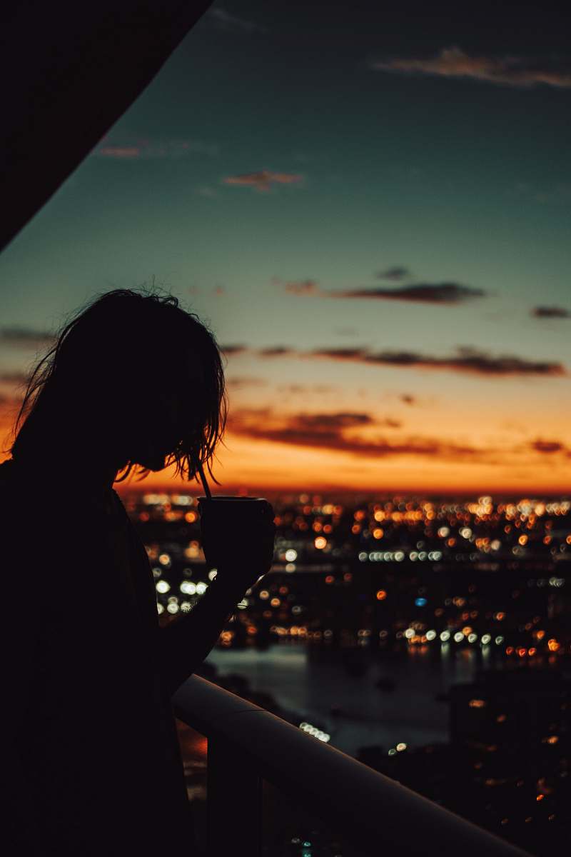 human silhouette of man holding mug during golden hour person