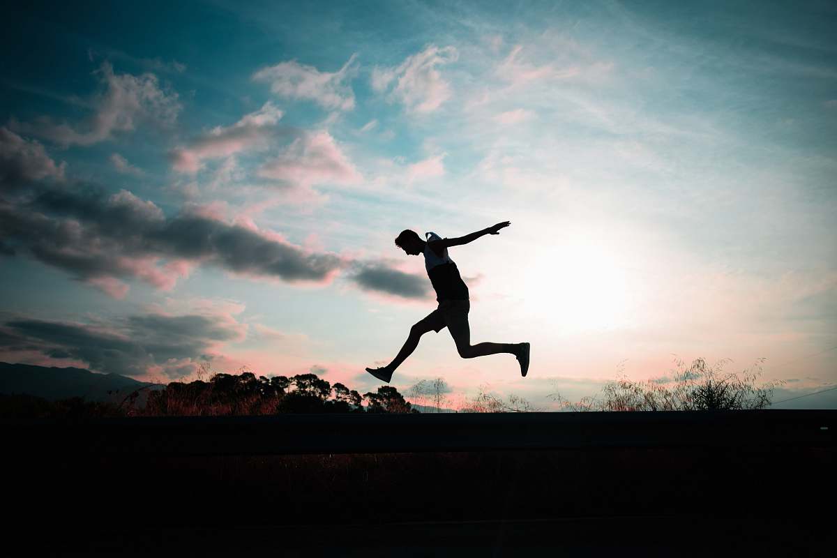 human silhouette of man jumping during golden hour person