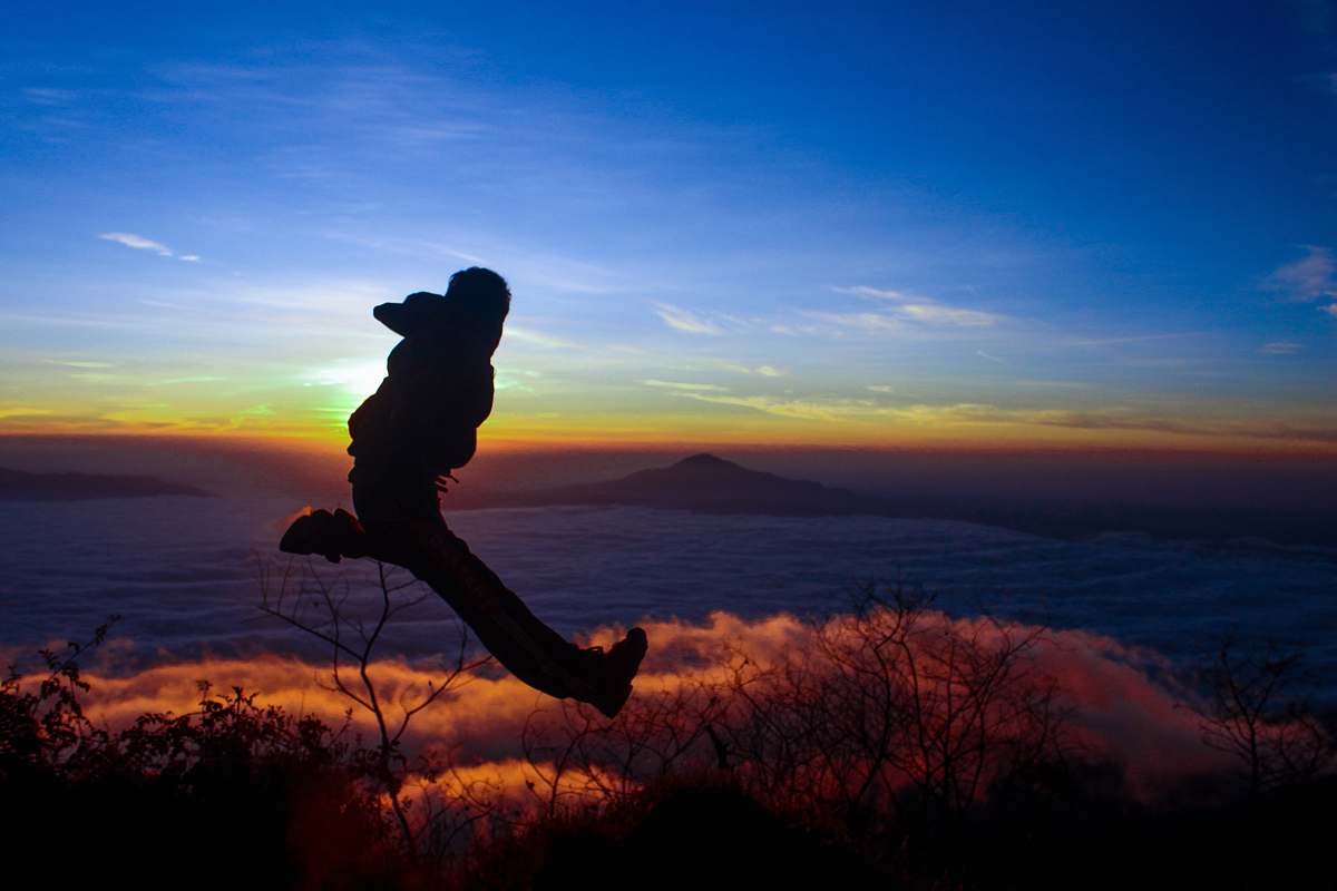 nature silhouette of man jumping on mid air outdoors