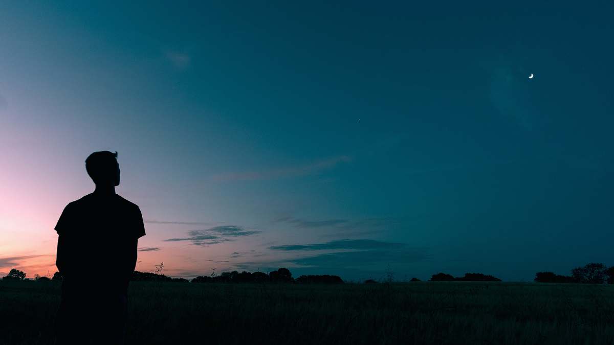 person silhouette of man looking star during sunset people