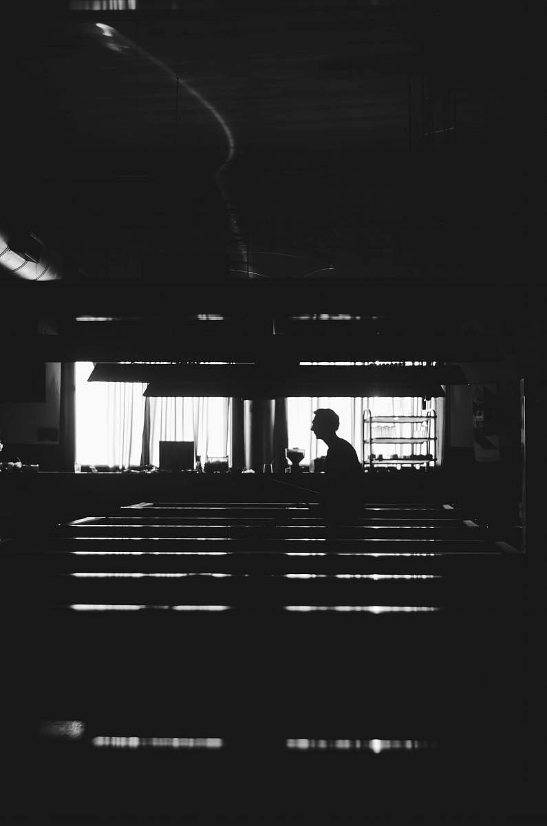 human silhouette of man near window black-and-white