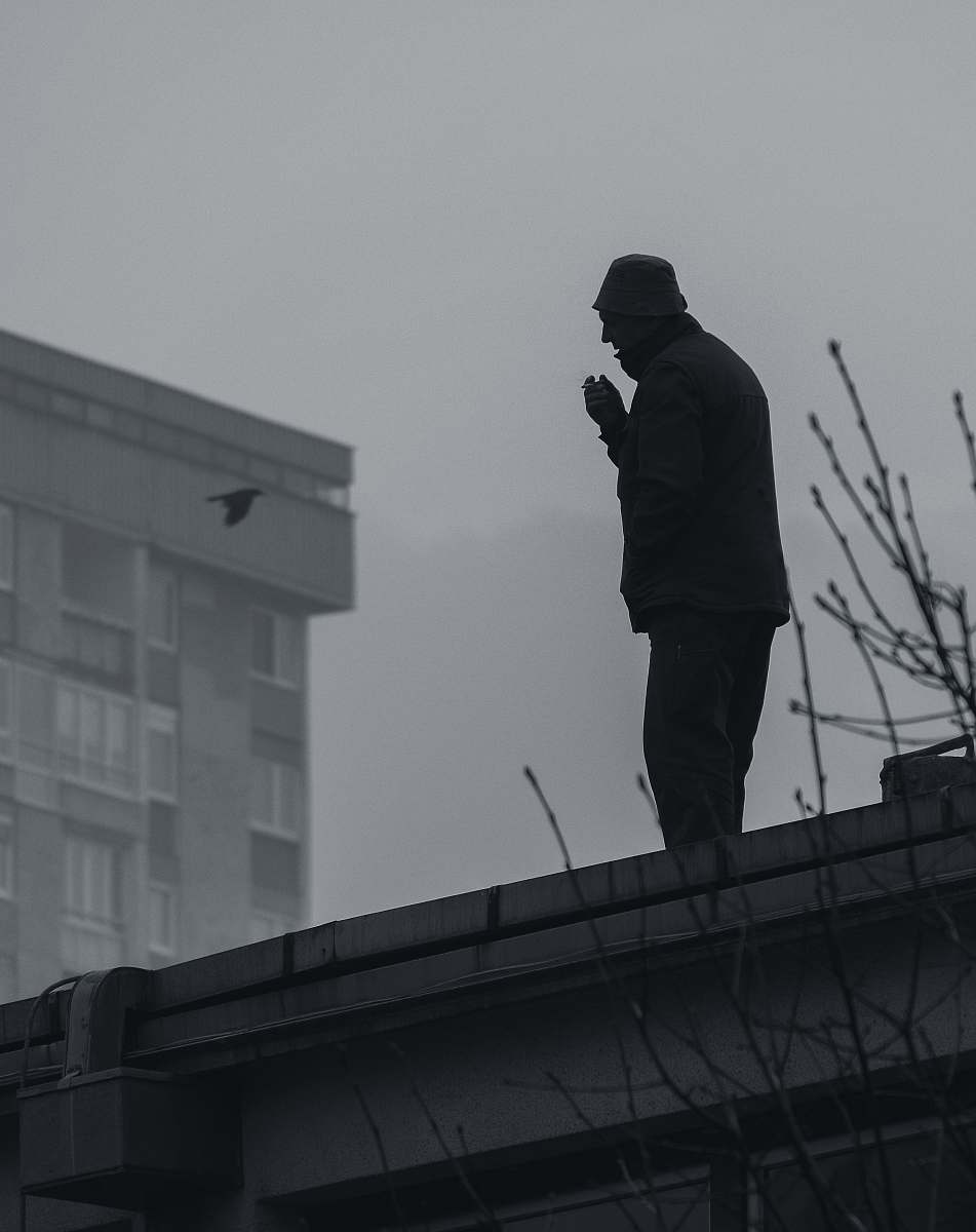 human silhouette of man on roof person