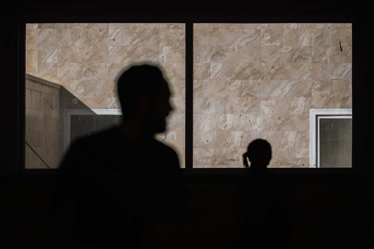 human silhouette of man standing beside window person