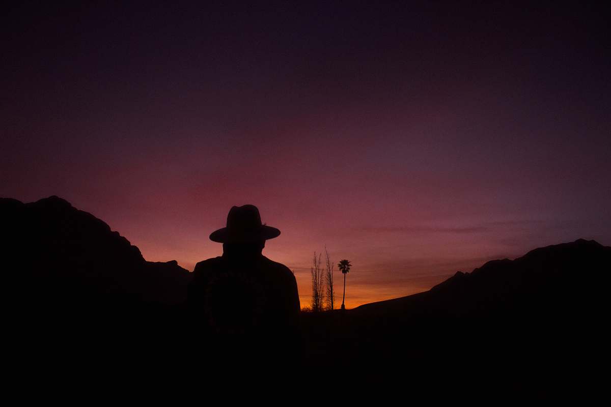 sky silhouette of man standing on mountain art