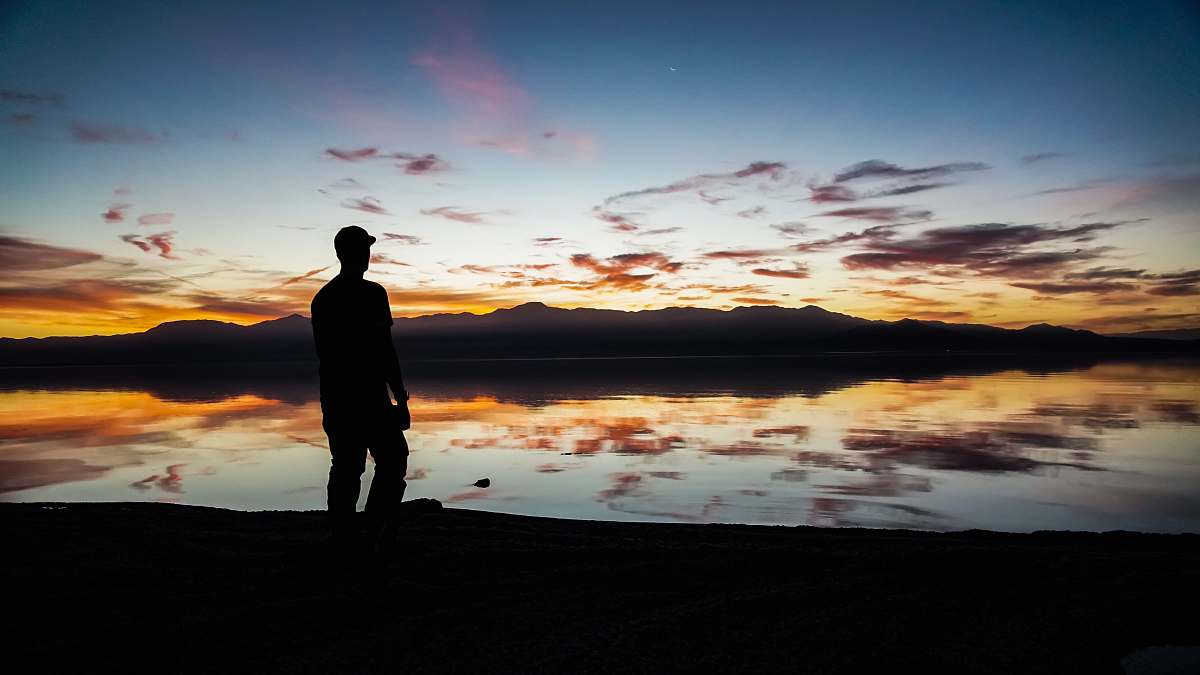 person silhouette of man standing on sand people