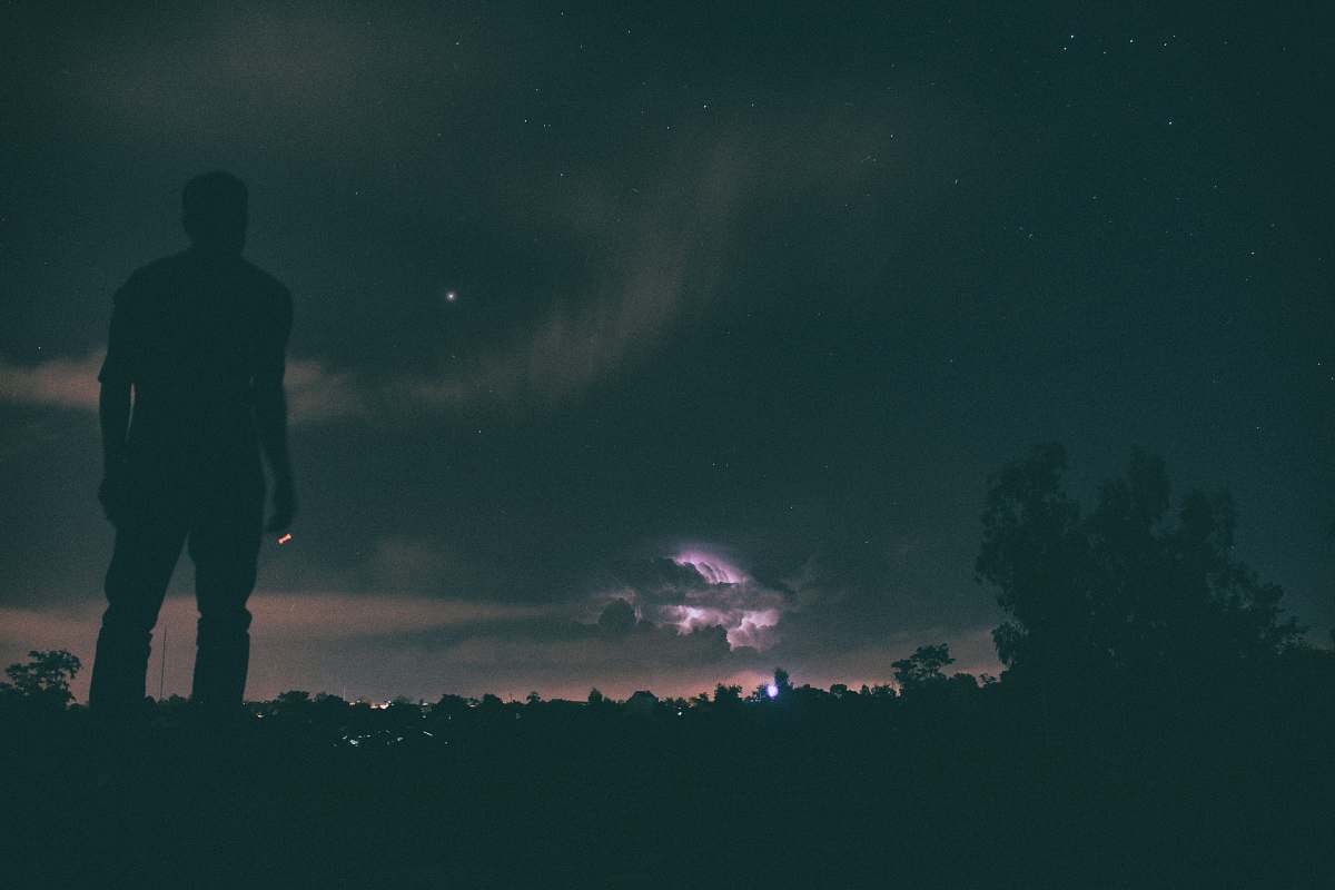 person silhouette of man standing under night sky people