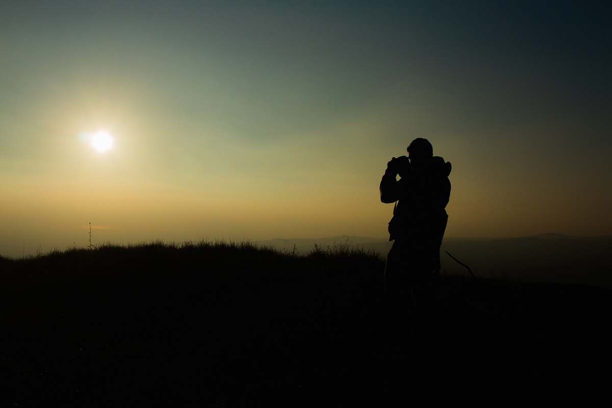 person silhouette of man taking picture during golden hour people