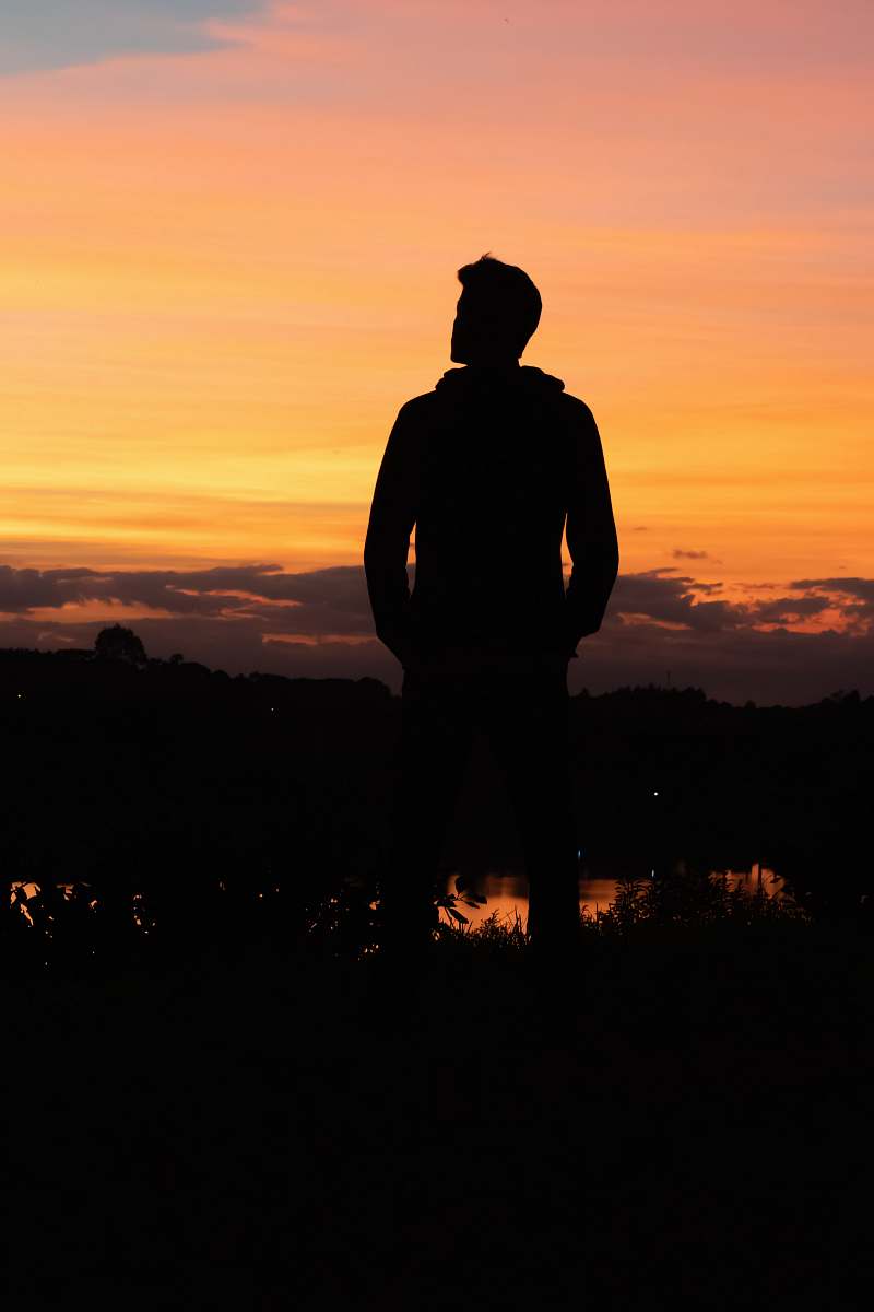 nature silhouette of man under yellow sky outdoors