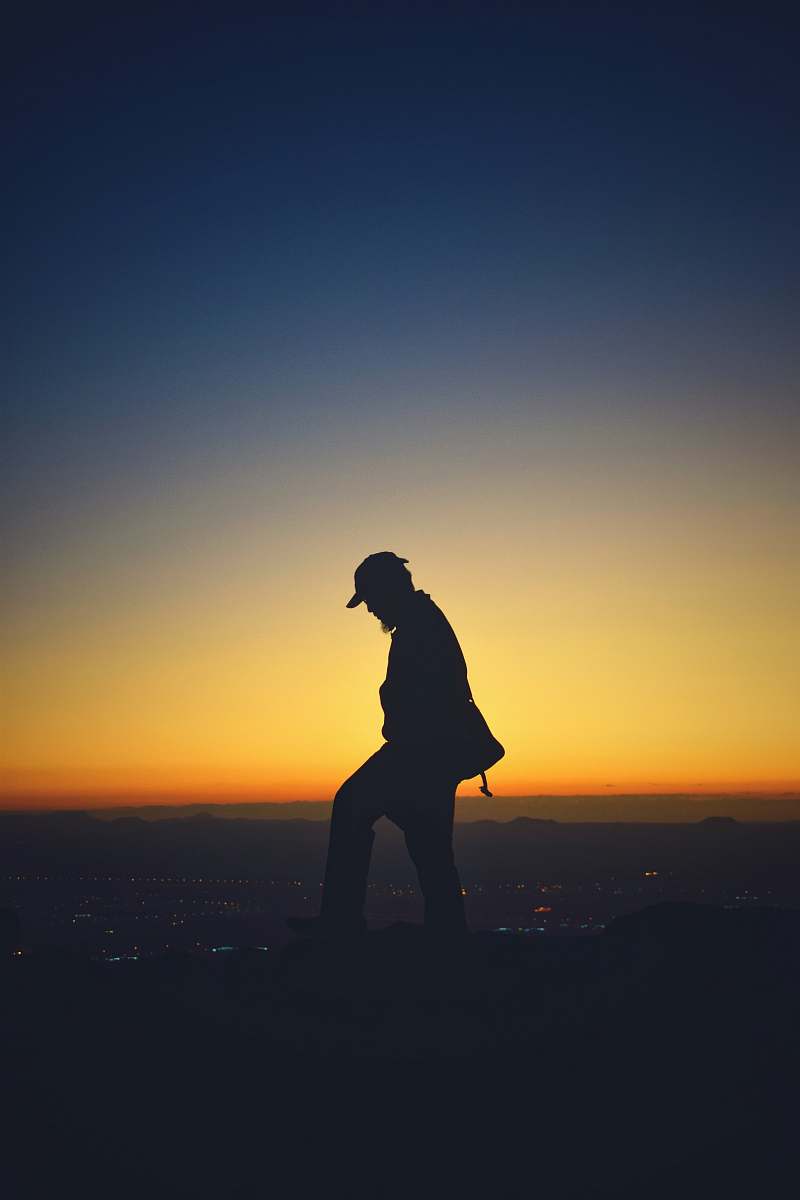 human silhouette of man wearing cap person