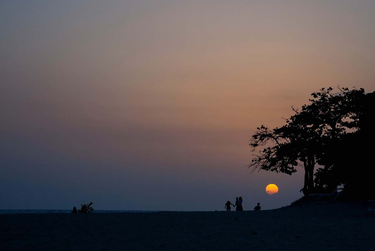 sky silhouette of people and tree during sunset cuba